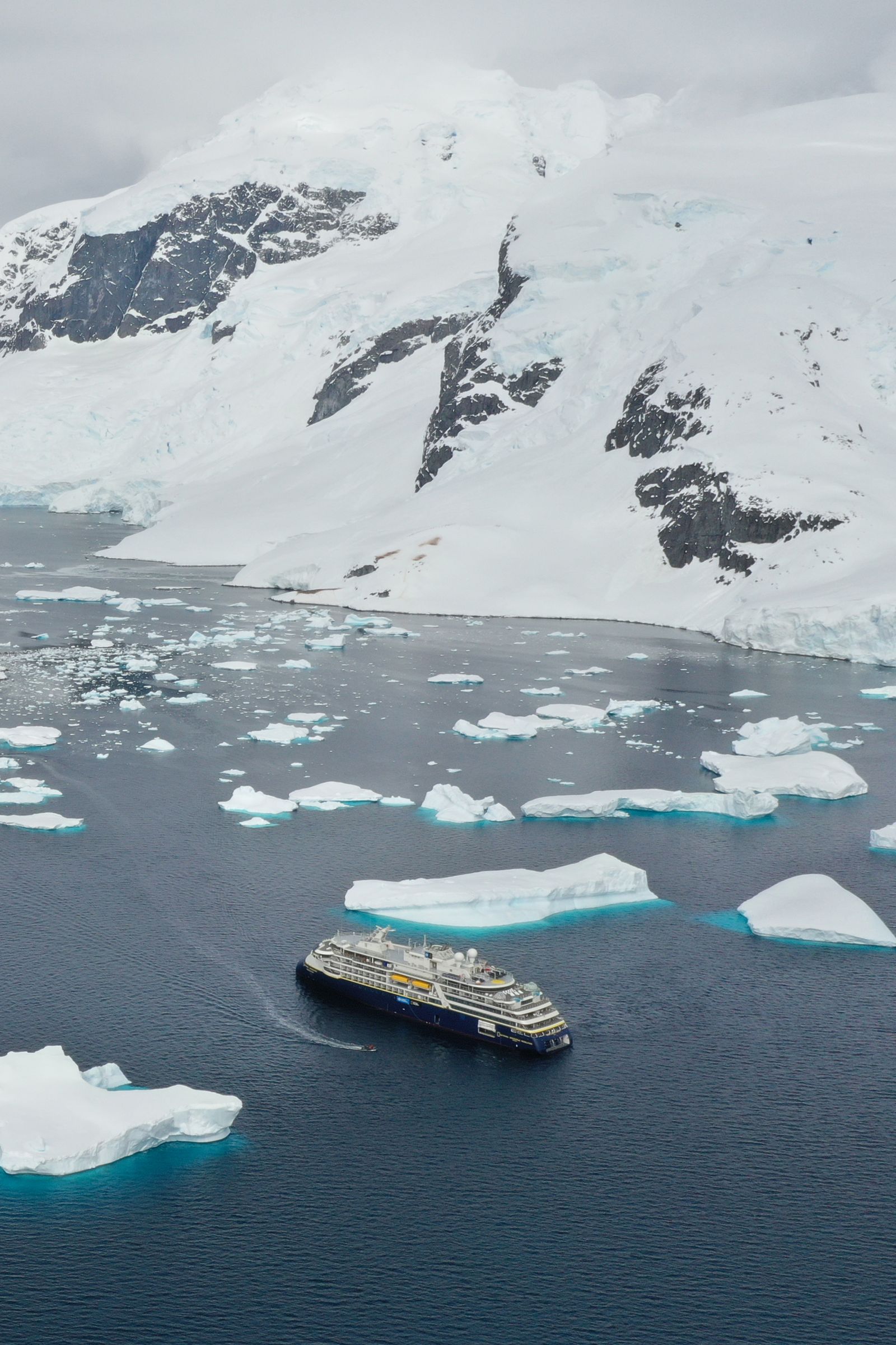 Image may contain Ice Boat Transportation Vehicle Nature Outdoors Glacier Mountain Watercraft Scenery and Ship
